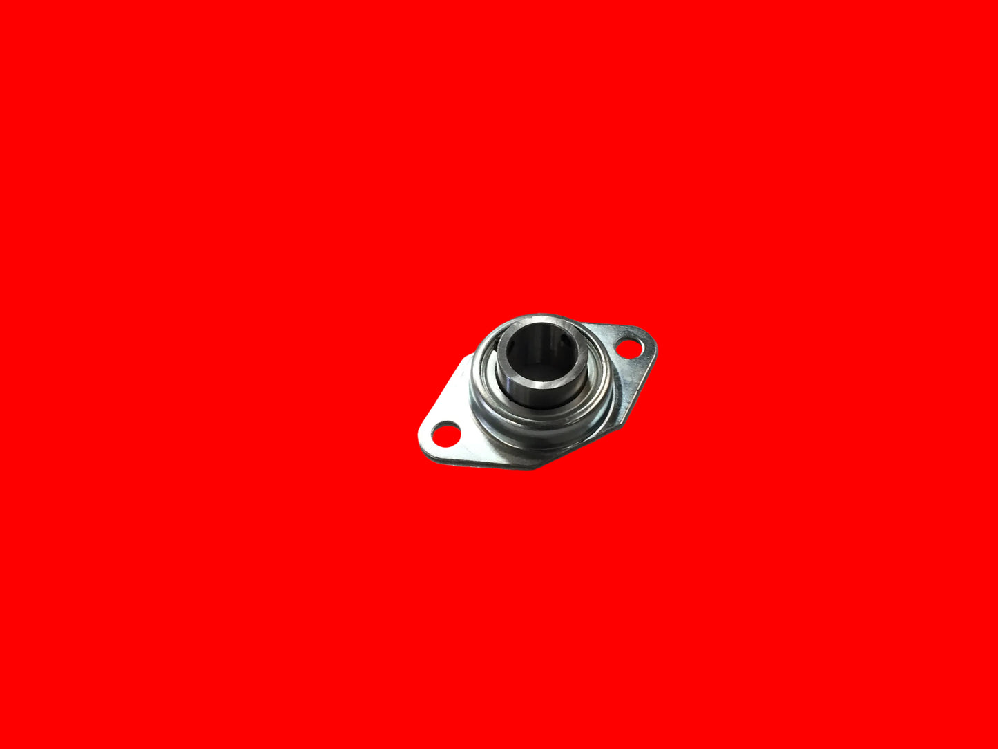Flange‑mounted metal bearing assembly with a round inner race and two bolt‑hole mounting plate, shown isolated on a red background.