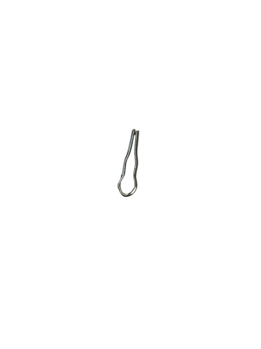 Top‑down view of a small silver metal cotter pin with a looped head and two narrow prongs, centered on a white sheet of paper with a neutral textured surface visible around the edges.