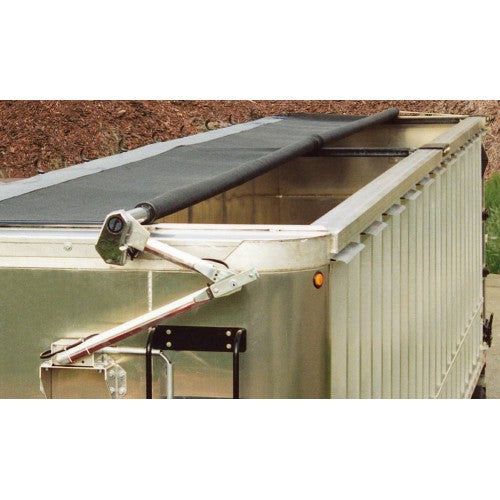 Close‑up view of a dump trailer fitted with a roll tarp system, showing the tarp roller, aluminum tarp arm, and end hardware mounted along the top edge of an aluminum trailer body.
